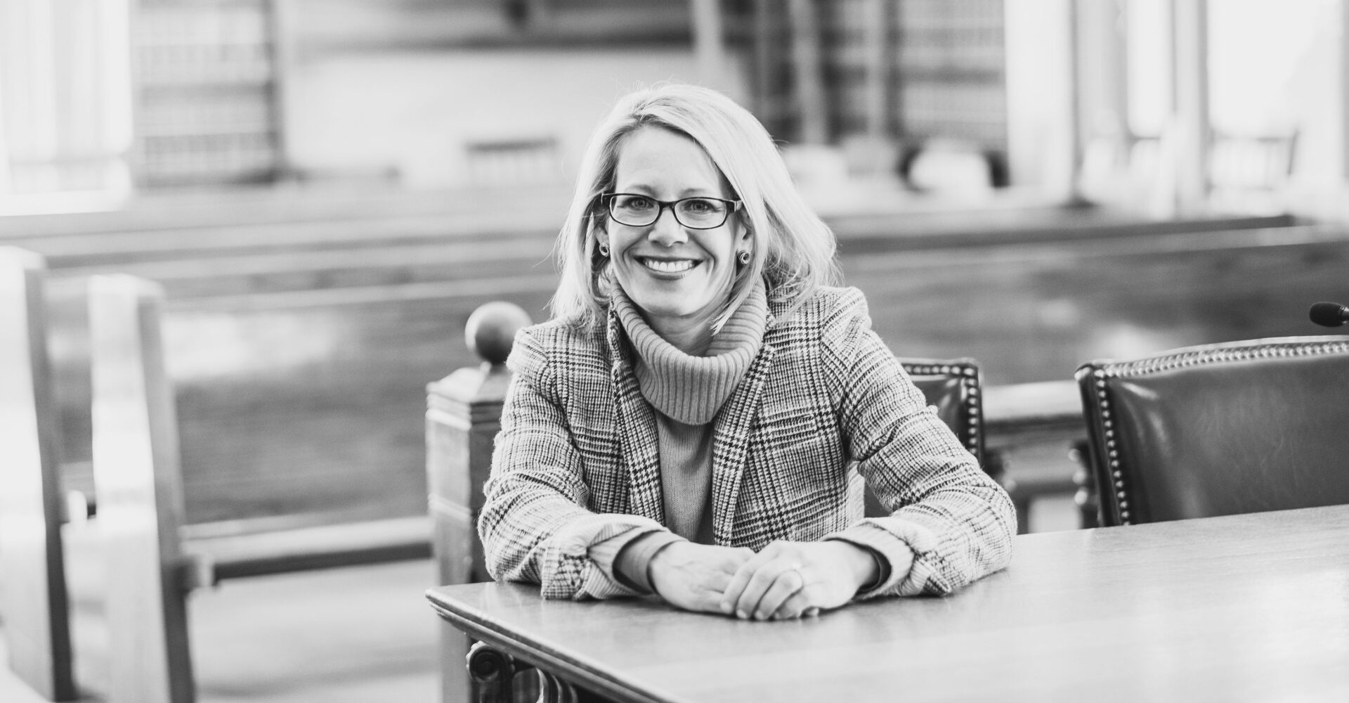 Jill Edinger seated at a courtroom table
